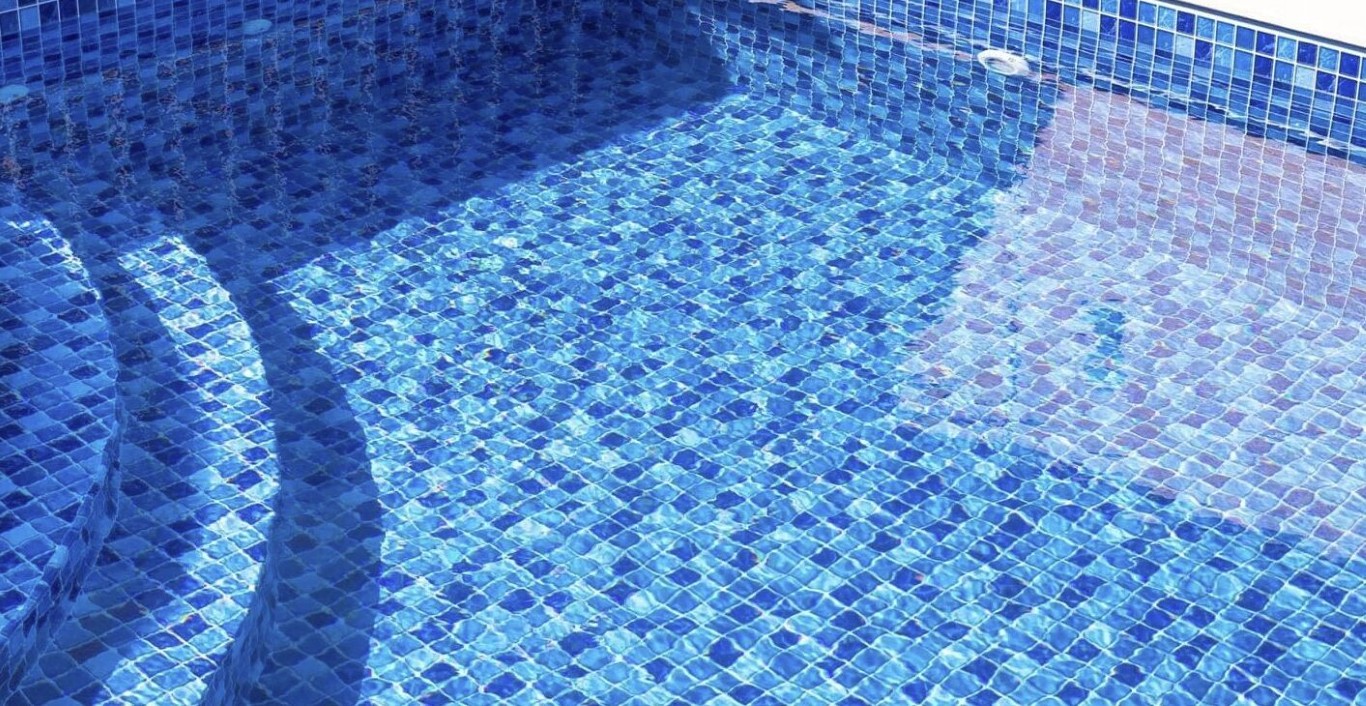 Crystal clear pool water maintained by professional weekly cleaning service